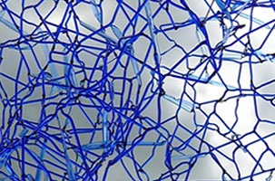 close up of delicate blue threads of glass fused together to look like a three dimensional web