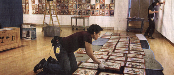 elizabeth lays out scores of norman rockwell saturday evening post covers on blankets to figure out the placement on the wall