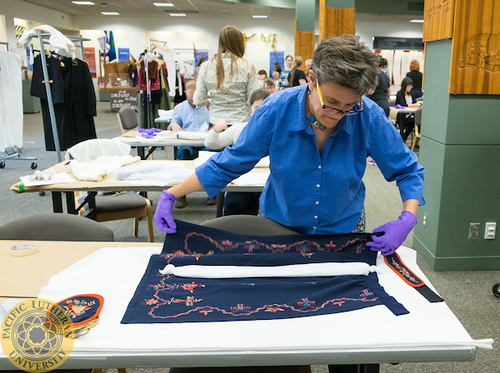 Elizabeth Mauro working with a costume at the Scandinavian Cultural Center